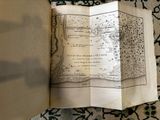 an open book sitting on top of a rug on top of a table