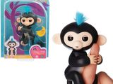 a toy monkey that is sitting on a finger
