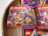 many legos that are sitting on a wooden table