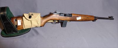 an old rifle with a hat on top of it sitting on a table