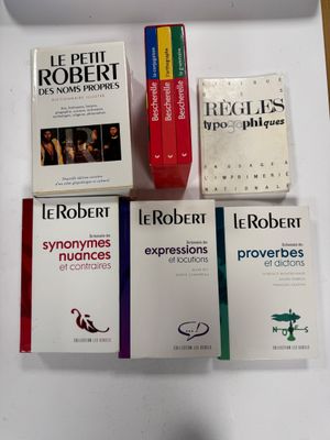 several books are sitting on a table next to a cup of coffee