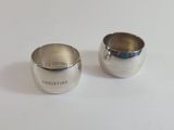 pair of silverplated sugar and creamers on a white surface
