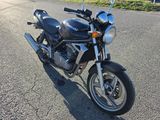 a motorcycle that is parked on the side of the road