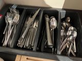 a drawer full of utensils and spoons in a kitchen