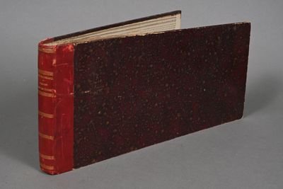 a book with a red cover sitting on a table