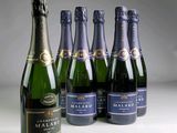 six bottles of champagne are lined up on a table
