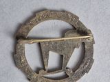 a close up of a metal pin with a horse on it