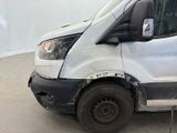 a white van that has been vandalized and is parked in a garage