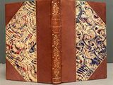 an old book with a brown cover with a pattern on it