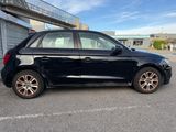 a picture of a black car parked in a parking lot