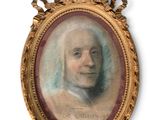 an antique portrait of a man in a gold frame on a white background