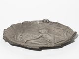 an image of a silver plate with a bird on it
