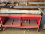 an image of a red work bench with two shelves underneath it