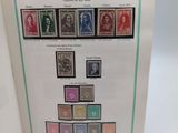 an open book with a picture of a group of stamps on it