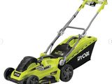 a green and black electric lawn mower on a white background