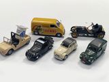 several toy cars are lined up next to each other on a white surface
