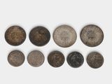 six different types of coins on a white surface