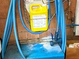 a blue hose that is connected to a water tank