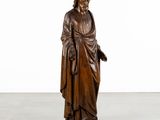 a wooden statue of a man with a beard and a robe