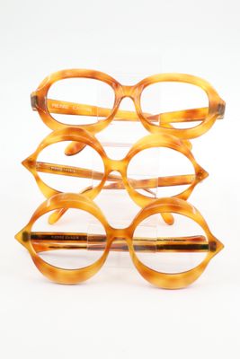 glasses are stacked on top of each other on a white surface
