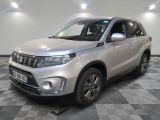 the silver suzuki suv is parked on a checkered floor