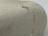 a close up view of a clay shoe on a white surface