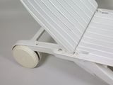 a white plastic lawn chair with wheels on a white surface