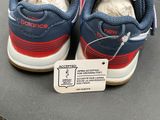 a pair of shoes with a tag on them on a table