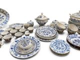 a lot of blue and white plates and bowls on the table
