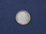 a silver coin with a portrait of a man on it