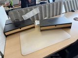 a laptop computer sitting on top of a wooden desk