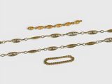 une collection de chaînes et de bracelets en or sur fond blanc