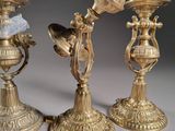 three gold candlesticks sitting next to each other on a table