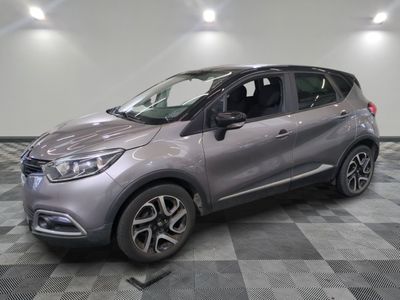 the grey car is parked on a checkered floor in the garage