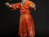 figurine of a man with a pipe in his mouth
