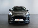 the front view of a grey ford fiesta parked in a showroom