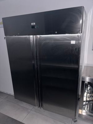 two refrigerators that are in the kitchen next to each other