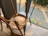 two chairs and a rocking chair on the porch