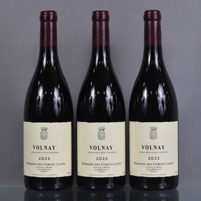 three bottles of red wine are lined up on a table