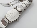 a close up of a watch on a white surface