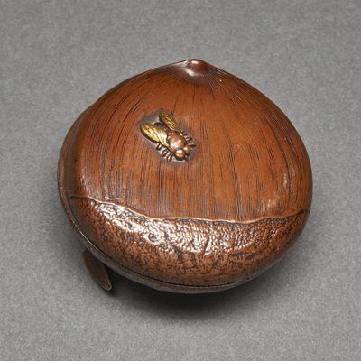 a wooden box with a bee on it on a table