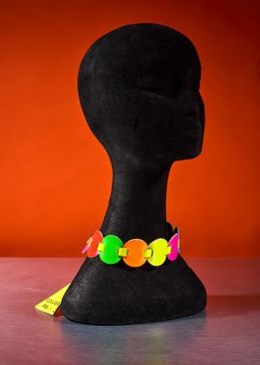 a black mannequin head with colorful buttons on it