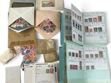 many different types of stamps and envelopes laid out on a table