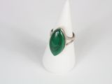 a close up of a ring with a green stone on it
