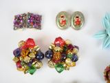 a lot of jewelry on a white surface