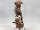 statue of a boy on a pedestal with a bird on his shoulder