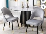 two chairs that are next to a table in a room