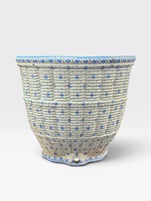 an image of a blue and white basket sitting on top of a table