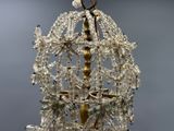 a chandelier made of glass beads hanging from the ceiling