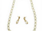 a white beaded necklace and earring set with a gold plated clasp